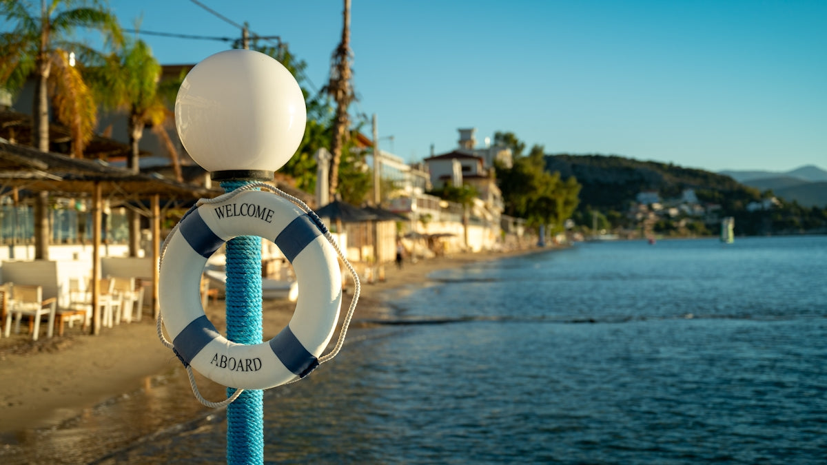 Life preserver on a pole overlooking a beach.