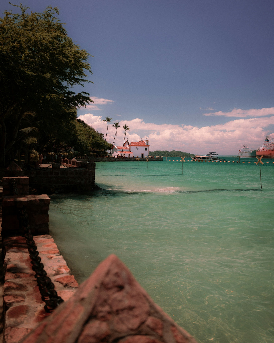 Tropical coastline with white building and clear water