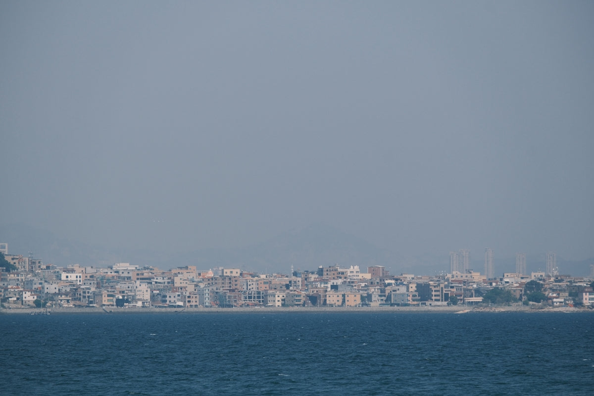 Coastal city skyline with buildings along the water