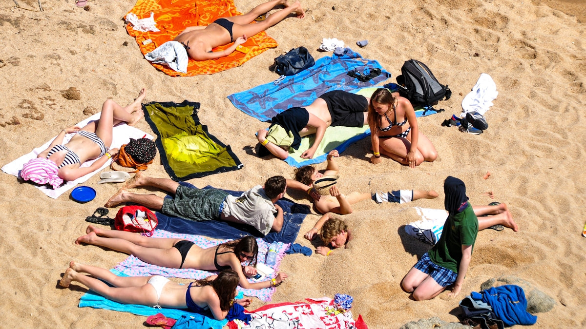 People sunbathing on a sandy beach
