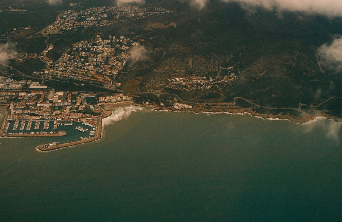 Aerial view of a coastal city with a harbor.